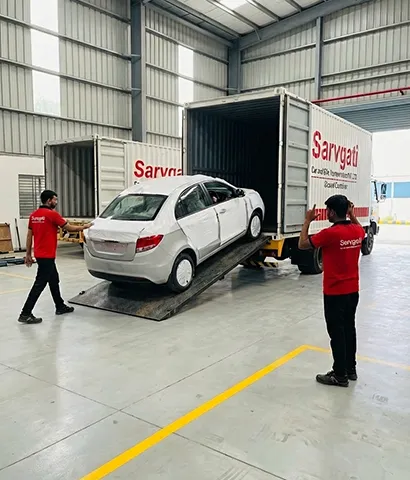 Car being carefully unloaded from a carrier