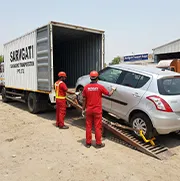 Sarvgati staff loading CH number plate car into closed container truck in Chandigarh