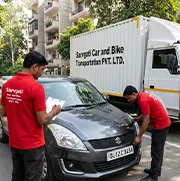 Sarvgati Car and Bike Transportation PVT. LTD. staff inspecting a car with Delhi number plate before pickup in Delhi