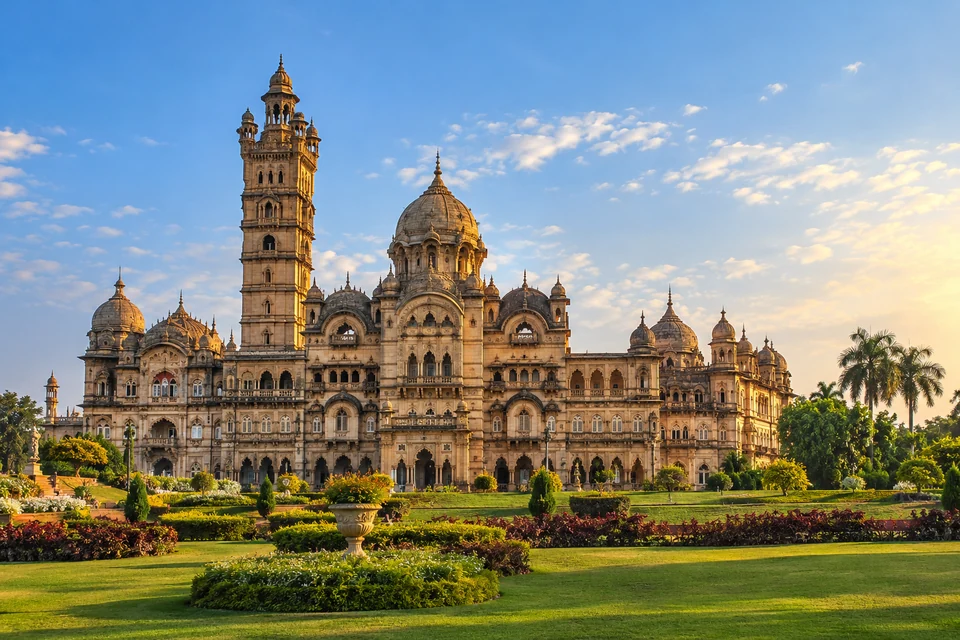 Illustration: Illustrative city view of Lakshmi Vilas Palace facade and landscaped grounds