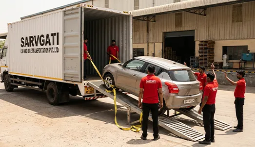 Professional team loading car into closed container truck in Jaipur