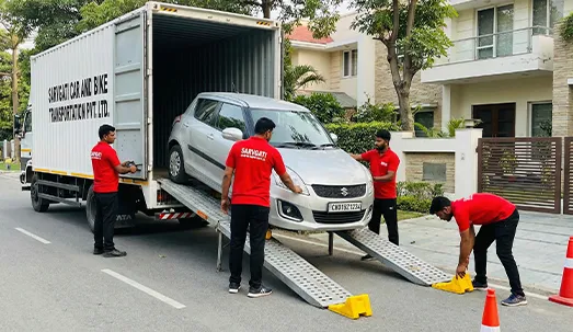 Sarvgati team loading a car into a closed container truck in Chandigarh with CH number plate