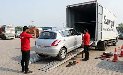 Professional car loading using ramps and safety equipment