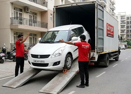 HR number plate car being safely unloaded from transport truck in Gurugram Haryana